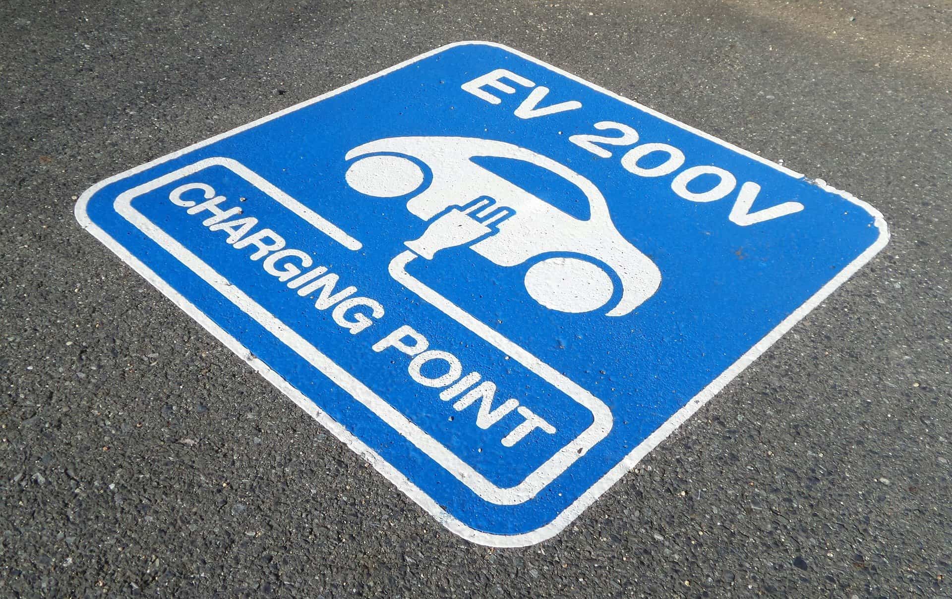 Electric vehicle charging sign painted on the road